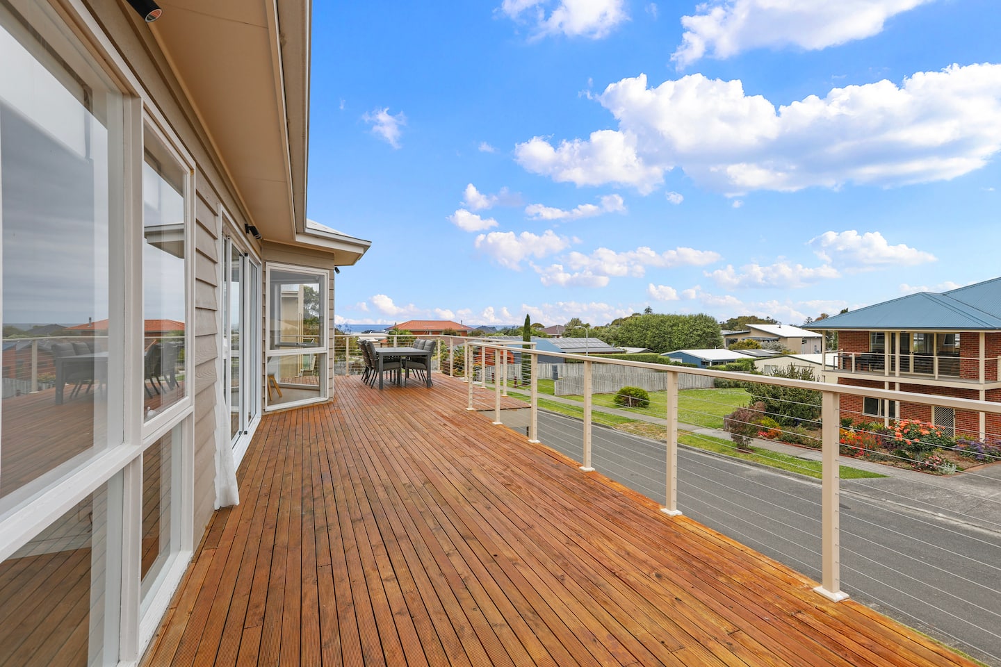 The long timber deck with glimpses of the sea beyond Apollo Bay rooftops