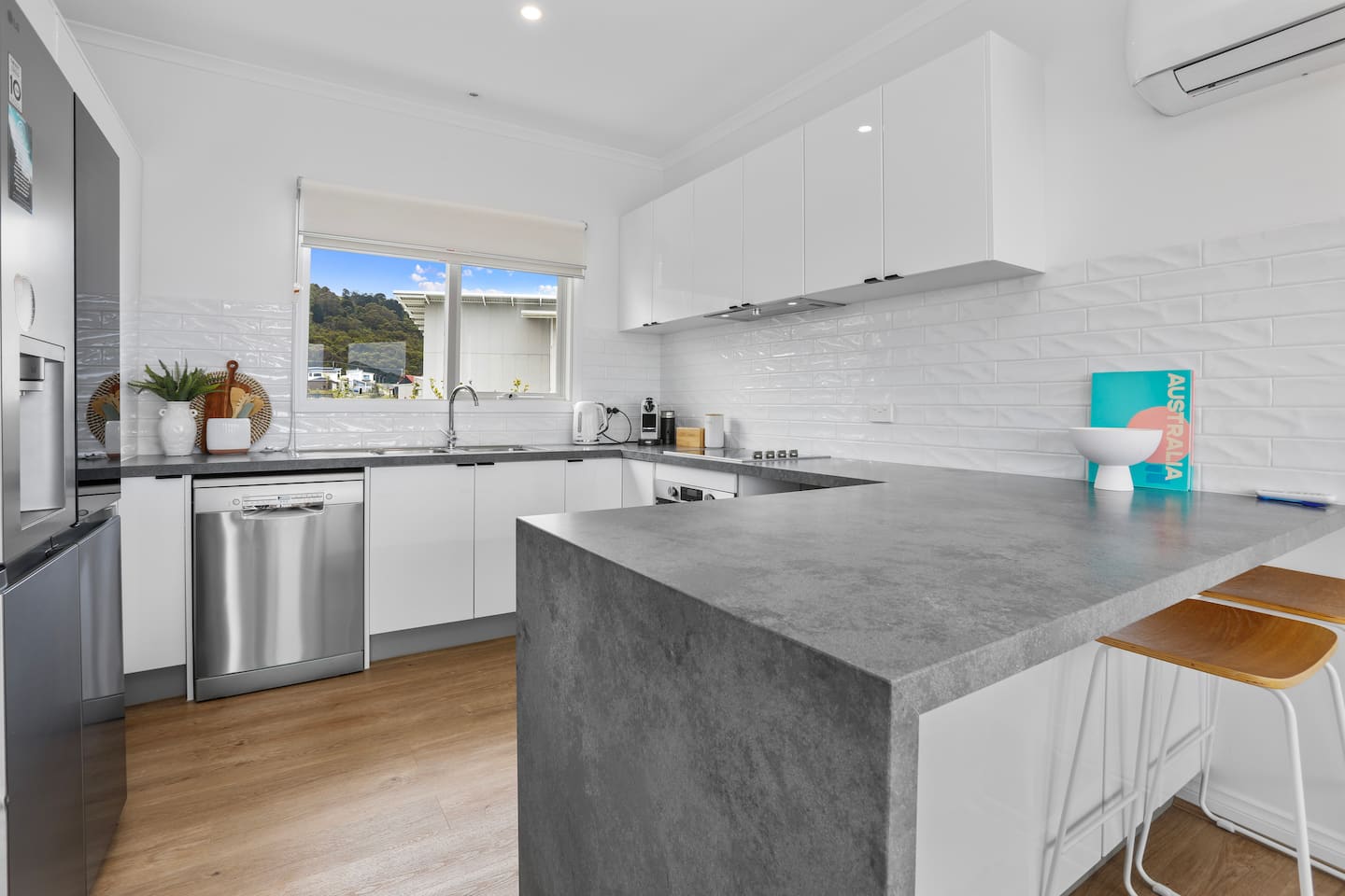 Modern kitchen with island seating and stainless steel appliances